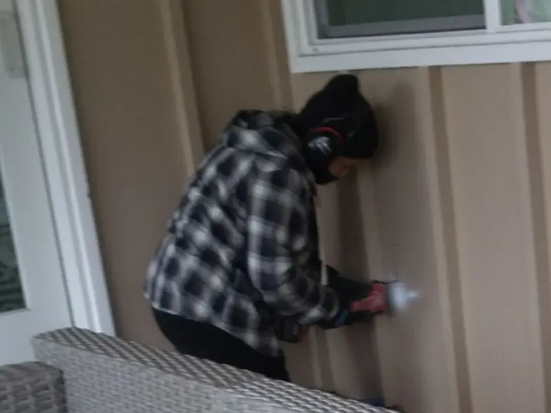 Professional electrician installing an exterior outlet in Sansom Park